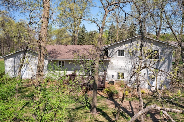 rear view of property featuring a deck