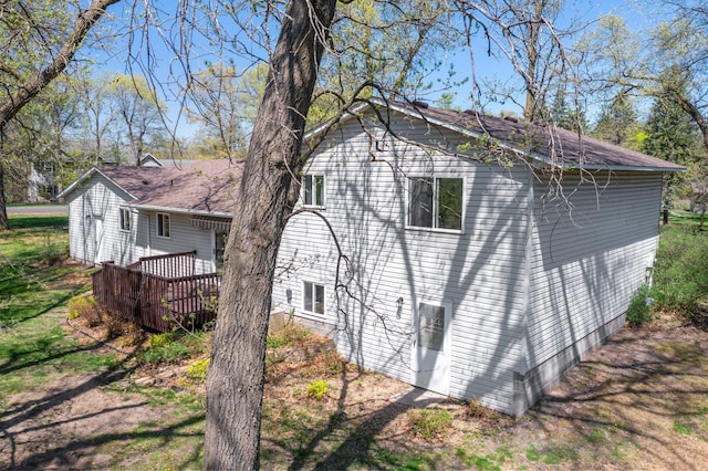 view of property exterior with a wooden deck