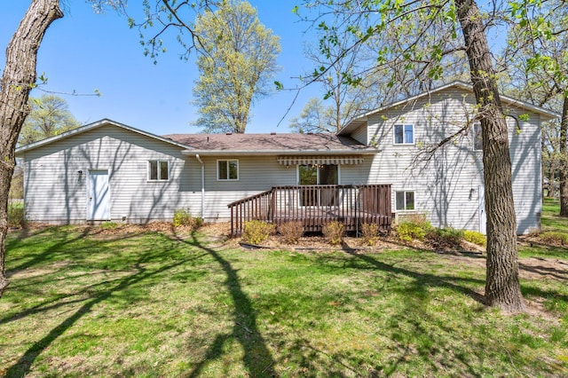 rear view of property with a deck and a lawn