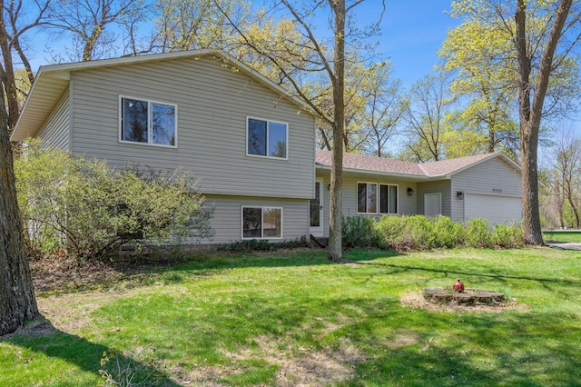 view of front of house with a garage and a front lawn