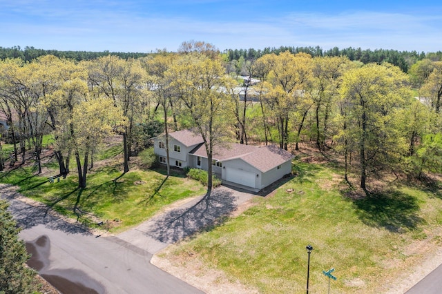 view of subject property featuring a heavily wooded area