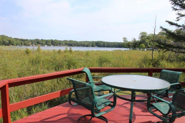 wooden deck featuring a water view