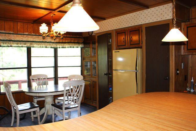 dining area featuring wood ceiling and a notable chandelier