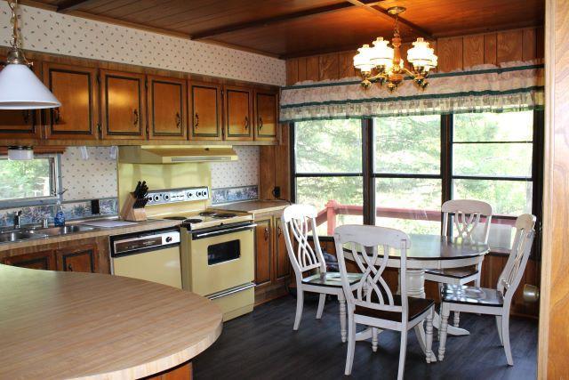 kitchen featuring an inviting chandelier, a sink, white appliances, wooden ceiling, and range hood
