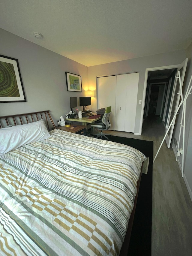 bedroom with a closet and baseboards