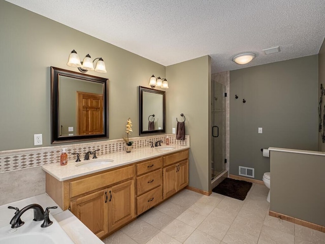 full bathroom with a sink, a stall shower, toilet, and visible vents