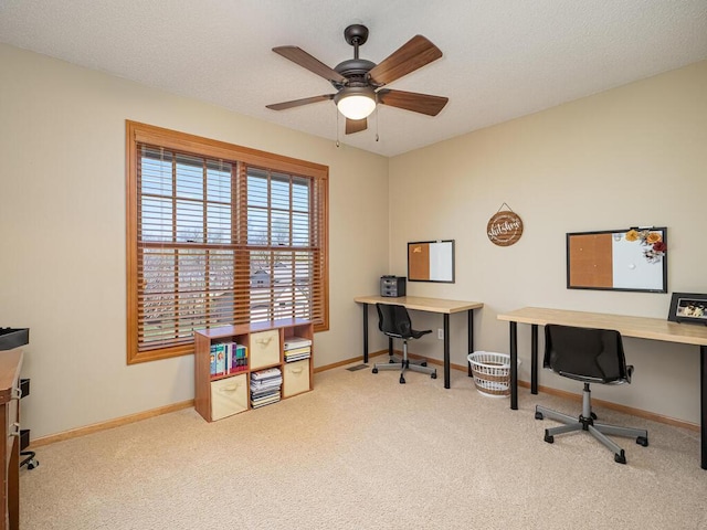 office space with ceiling fan, baseboards, and carpet