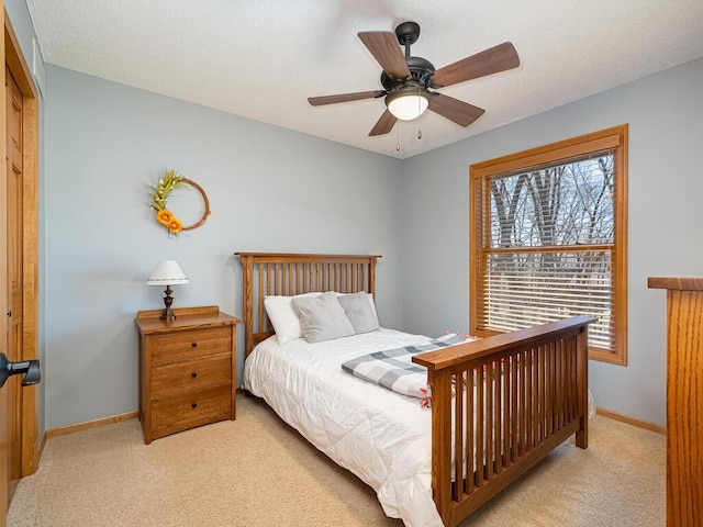 carpeted bedroom with baseboards and ceiling fan