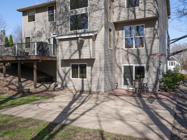 rear view of property with a patio area and a wooden deck