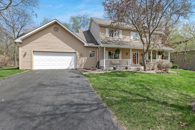 traditional-style house featuring covered porch, an attached garage, driveway, and a front lawn