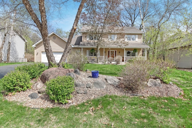 view of front facade with covered porch, aphalt driveway, a front lawn, and a garage
