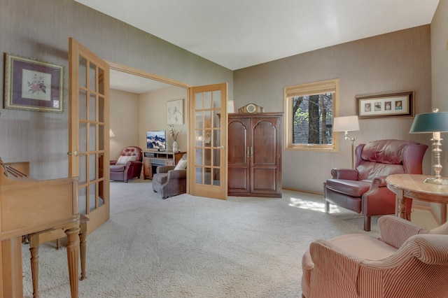 sitting room featuring carpet floors and french doors