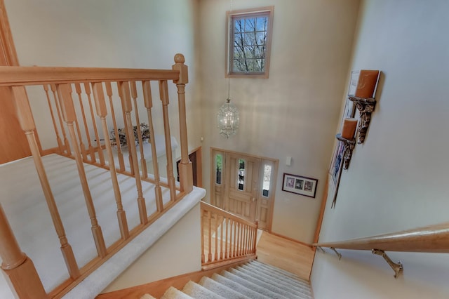 stairs with an inviting chandelier