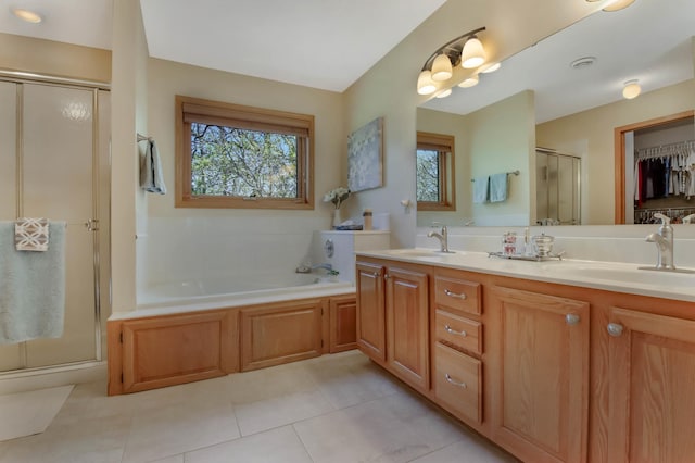 full bath featuring a sink, tile patterned floors, a stall shower, and a bath