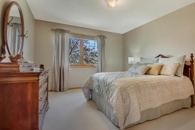 carpeted bedroom featuring baseboards