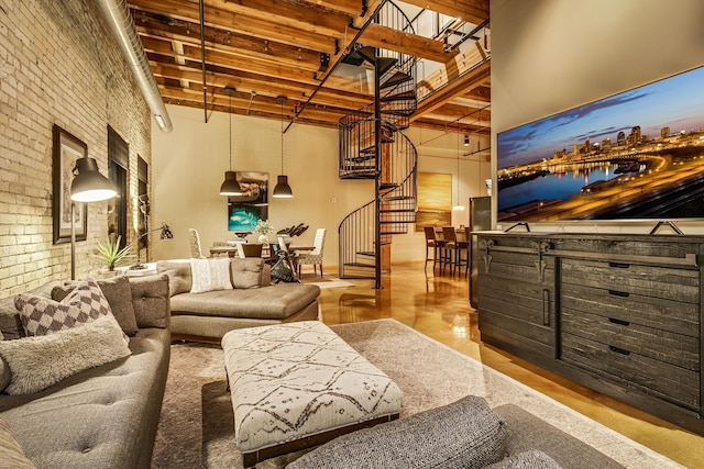 406 Wacouta St Unit 707, Saint Paul, MN 55101 - living room with stairway, a high ceiling, beam ceiling, and brick wall