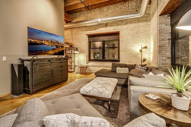 406 Wacouta St Unit 707, Saint Paul, MN 55101 - living area with brick wall, a high ceiling, and wood finished floors