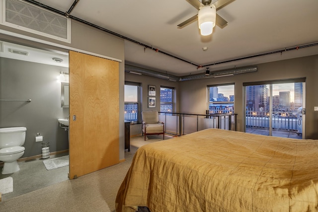 406 Wacouta St Unit 707, Saint Paul, MN 55101 - bedroom with visible vents, access to exterior, multiple windows, and ensuite bath