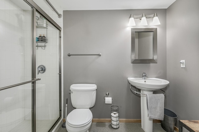 406 Wacouta St Unit 707, Saint Paul, MN 55101 - bathroom featuring baseboards, a sink, toilet, and a shower stall