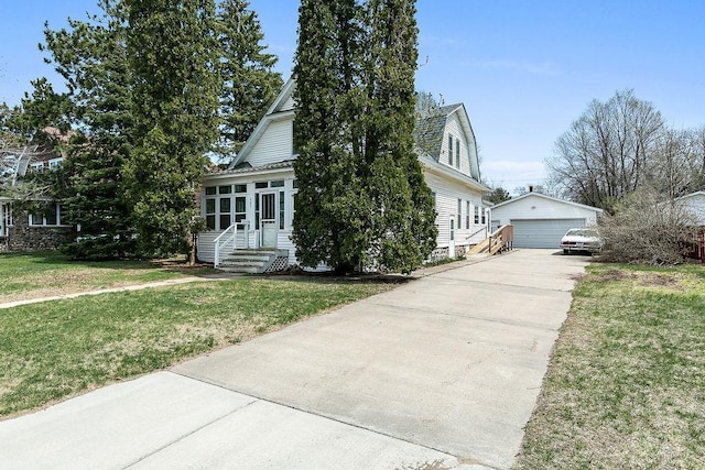 view of front facade featuring a detached garage, an outbuilding, a gambrel roof, and a front lawn