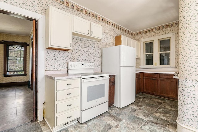 kitchen with wallpapered walls and white appliances