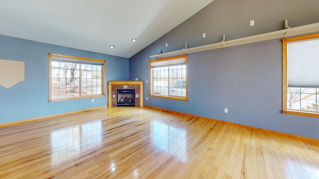11544 Lake Eunice Rd, Detroit Lakes, MN 56501 - unfurnished living room featuring wood-type flooring, lofted ceiling, a fireplace, baseboards, and recessed lighting