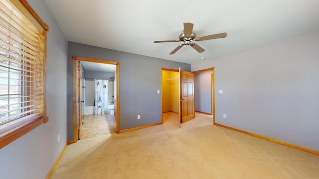 11544 Lake Eunice Rd, Detroit Lakes, MN 56501 - unfurnished bedroom with baseboards, light carpet, a walk in closet, a closet, and connected bathroom