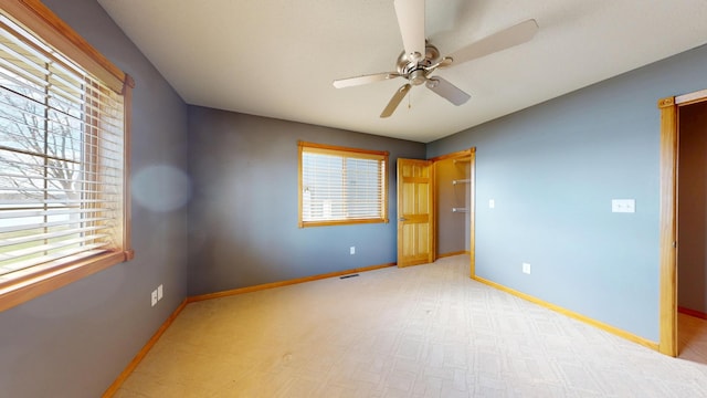 11544 Lake Eunice Rd, Detroit Lakes, MN 56501 - unfurnished bedroom with multiple windows, baseboards, ceiling fan, and light carpet