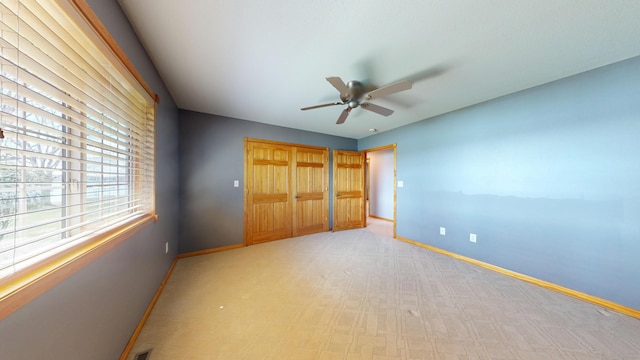 11544 Lake Eunice Rd, Detroit Lakes, MN 56501 - unfurnished bedroom with baseboards, a closet, light carpet, and ceiling fan