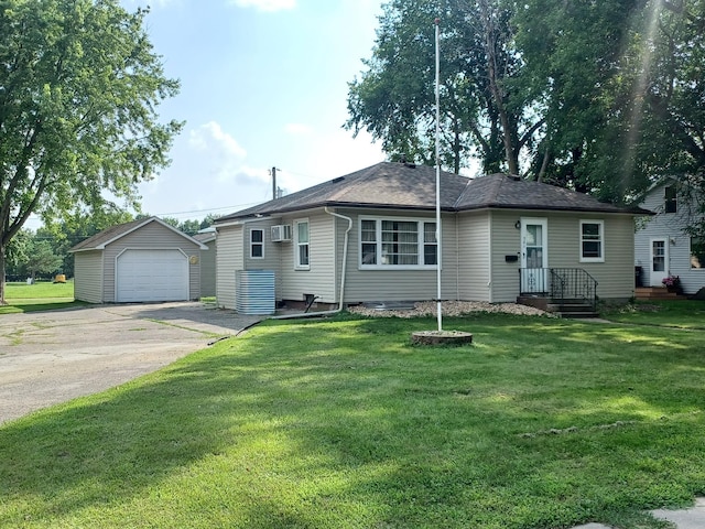 view of front facade featuring a front lawn, a detached garage, a wall mounted air conditioner, an outdoor structure, and driveway