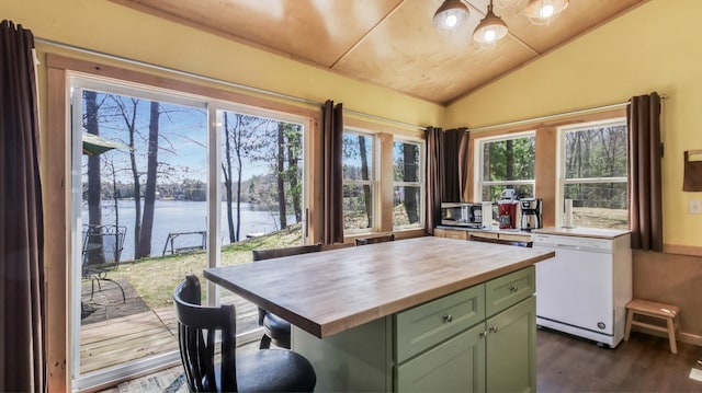 kitchen featuring butcher block counters, green cabinetry, a water view, dishwasher, and vaulted ceiling