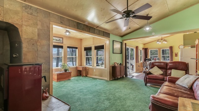 carpeted living room featuring a wood stove, a ceiling fan, and lofted ceiling