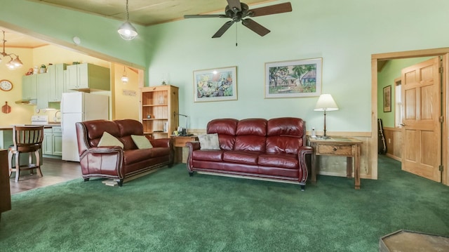 carpeted living room featuring crown molding and a ceiling fan