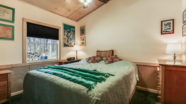 carpeted bedroom featuring ceiling fan and vaulted ceiling