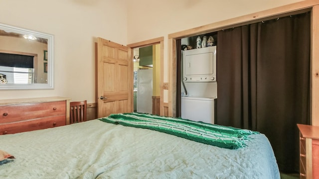 bedroom with stacked washer / dryer