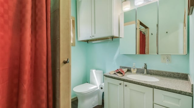 bathroom with vanity, a shower with curtain, and toilet