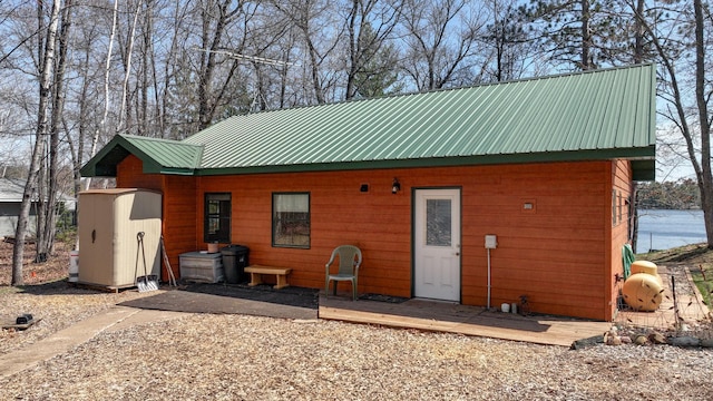 back of property featuring metal roof