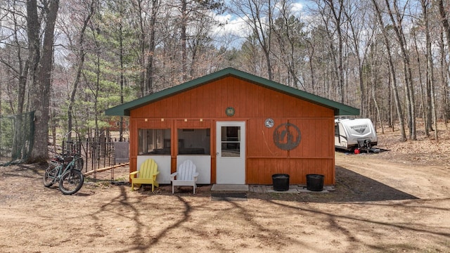 view of outbuilding featuring a view of trees
