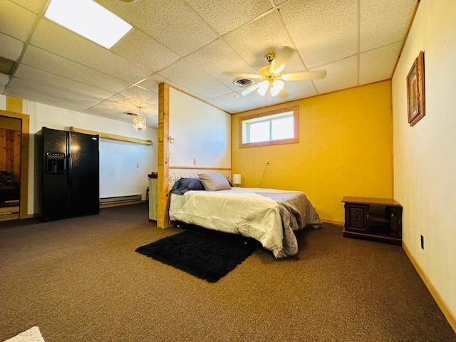 bedroom featuring carpet floors, black refrigerator with ice dispenser, a paneled ceiling, and visible vents