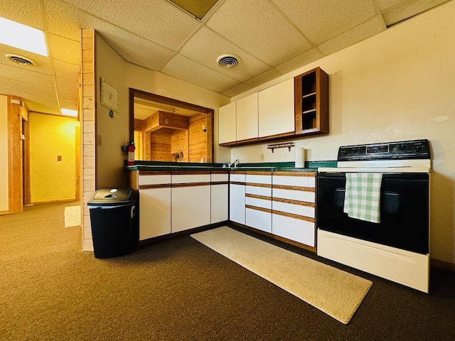 kitchen featuring white cabinetry, a drop ceiling, white electric stove, and visible vents