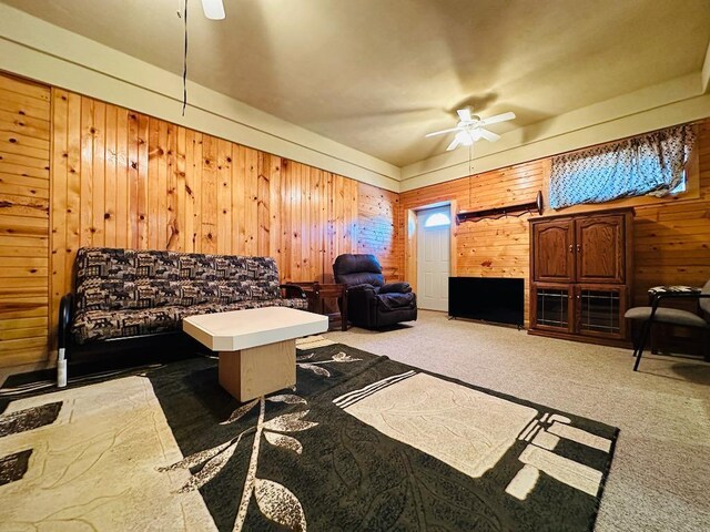 carpeted office with wooden walls and ceiling fan