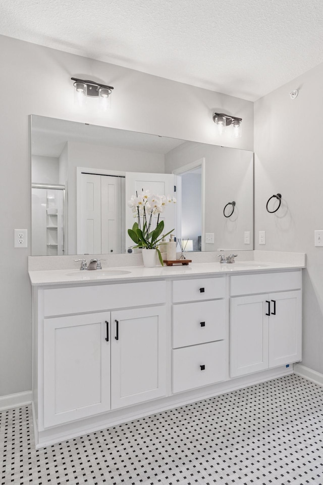 8678 London Cir NE Unit B, Blaine, MN 55449 - bathroom with a sink, double vanity, and baseboards