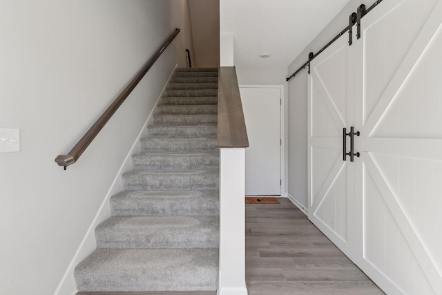 8678 London Cir NE Unit B, Blaine, MN 55449 - staircase with a barn door and wood finished floors