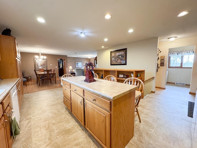 kitchen with a breakfast bar area, recessed lighting, visible vents, and a kitchen island