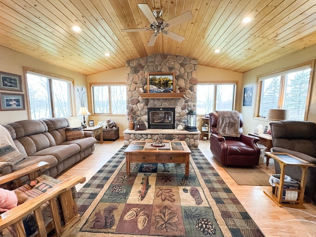 living room with wood ceiling, vaulted ceiling, a wealth of natural light, and a fireplace