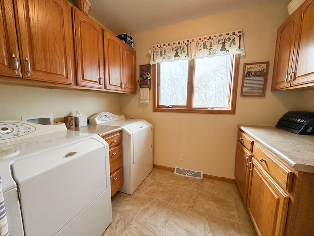 laundry room featuring cabinet space, washer and dryer, baseboards, a toaster, and visible vents
