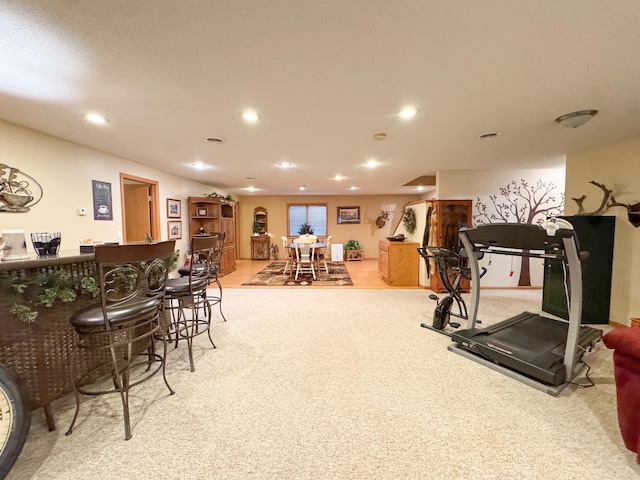 workout room with recessed lighting, a dry bar, and light colored carpet