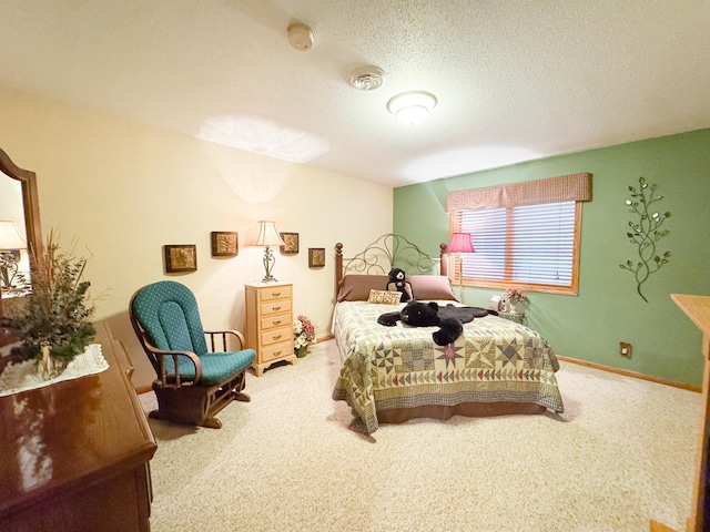 bedroom featuring a textured ceiling and carpet