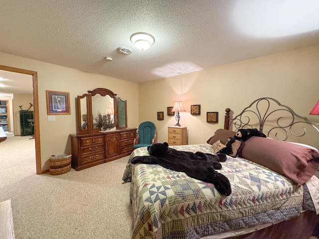 bedroom with carpet floors and a textured ceiling