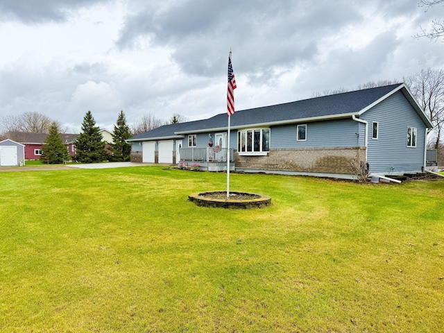 back of property with a lawn and brick siding